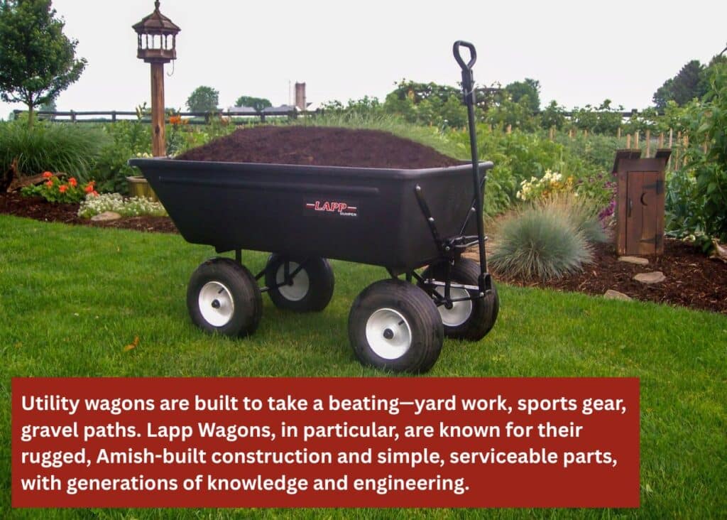 Heavy-duty utility wagon loaded with mulch, showing rugged construction built for landscaping and outdoor work. Caption: Utility wagons are built to take a beating—yard work, sports gear, gravel paths. Lapp Wagons, in particular, are known for their rugged, Amish-built construction and simple, serviceable parts, with generations of knowledge and engineering.